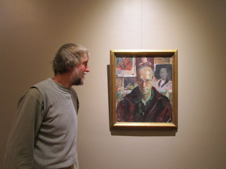 Steve Shepstone hangs a painting of Wayman Adams by James N. Rosenberg as a lighting test in the new Rosenberg Gallery. The Adirondack History Museum’s 2016 season focuses on programming highlighting Essex County artists as part of its celebration for the gallery opening. (Photo provided by the Adirondack History Museum)
