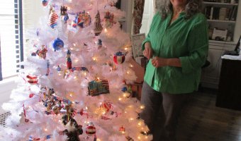 Barbara Steen of Jay finishes decorating her patriotic theme tree for Hancock House's Festival of Trees.