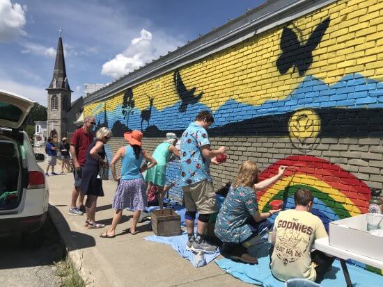 The community mural painted during the 2021 festival by 60 volunteers will be dedicated during this year's activities.
